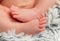 Tender newborn baby feet with tiny toes, macro