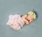 Tender newborn sleeping with wreath on head