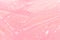 Tender pastel pink slime background with gold glitter glowing and drip lines, top view.