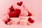 Tender pastel pink stage mockup with three different round podiums, fly passion red and pink paper hearts of asian fans in chinese