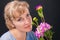 Tender pensive woman 45 years old with flowers