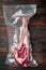 Tender raw trimmed bone-in ribeye tomahawk steak in pack, on old dark  wooden table background, top view flat lay