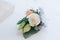 Tender rose and blue flower put in a boutonniere