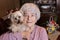 Tender senior woman holding Yorkshire terrier