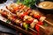 Tender Szechuan chicken skewers with red bell peppers and onions served on a wooden board with a side of tangy peanut sauce