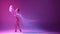Tender, talented young girl, ballerina in beige bodysuit dancing with transparent veil against gradient pink purple