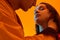 Tender teenage couple on orange background