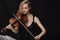 Tender violin embrace captures performance\'s intimate essence