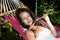 Tender woman hold spikelet while laying in hammock. attractive girl sleep in hammock. lady relax in hammock. beauty and sensuality