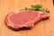 Tenderized Steak on a Wooden Cutting Board