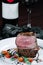 Tenderloin steak on plate with bottle of wine and wineglass