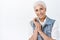 Tenderness, aging and cosmetology concept. Modern cute and happy smiling senior woman with combed grey hair, clasping