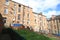 Tenements with back gardens and blue skies