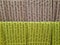 TENERIFE, 2021: Background of rolls of pistachio green and ocher fabric with Indian writing, ethnic fabrics and interior