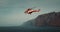 TENERIFE, CANARY ISLANDS, SPAIN, 2023 April: Rescue helicopter flies over a stormy ocean near rocky coastline. Los