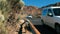 Tenerife, Canary Islands, Spain - January, 2019: Cars drive along a mountain asphalt road in the desert. Against the