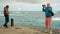 Tenerife, Canary Islands, Spain - January, 2019: Senor bald tourist in red shorts uses camera on the ocean, In the