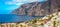 Tenerife island on a summer day panoramic landscape. Amazing aerial view on ocean and rocks. Seaside resort.