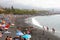 TENERIFE, SPAIN - JUNE 2, 2019: Purto de la Cruz cityscape with Playa Jardin black beach with bathers, Tenerife