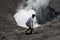 Tenggerese man walking on the edge of an active volcano