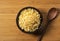 Tenkasu and wooden spoon served in a bowl placed on a wooden background