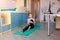 Tennage girl doing fitness gymnastics at home. Gymnastics exercises video tutorial. Children`s activity in quarantine during