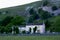 The Tennants Arms Hotel next to Kilnsey Crag in Evening Sunlight, Wharfedale, Yorkshire Dales, England