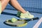 Tennis athlete player woman legs and feet wearing tennis shoes trainers. Fashion yellow activewear outfit on blue