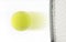 Tennis ball hit by raquet on white background