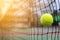 Tennis ball hitting to net on blur court