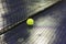 Tennis ball and net on wet ground after raining