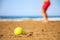 Tennis ball on a sandy beach