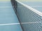 Tennis blue hard court with net before competition in sunny day