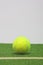 Tennis composition. Yellow ball, line and grenn grass tennis court