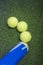 Tennis concepts: three tennis balls close to a container lie on