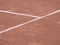 Tennis lines on terrain with footsteps