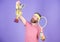 Tennis match winner. Achieved top. Tennis player win championship. Athlete hold tennis racket and golden goblet. Win