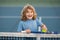 Tennis is my favorite play. Portrait of a pretty sporty child with a tennis racket. Little kid smiling tennis court