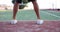 Tennis player bounces ball on tennis court closeup on feet