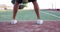 Tennis player bounces ball on tennis court closeup on feet