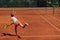 The tennis player focuses intently, perfecting her serve on the tennis court with precision and determination