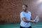 Tennis player giving a backhand swing on tennis court
