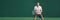 Tennis player man focused in ready position. A male athlete waiting for serve on panoramic green background banner
