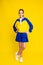 tennis player teen girl in sport wear stand in full height over yellow background