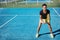 Tennis player woman playing doubles game on blue hard court in outdoor sports club. Asian girl realdy to play