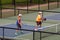 Tennis players playing doubles in the tennis court of Monument Valley Park