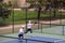 Tennis players playing doubles in the tennis court of Monument Valley Park