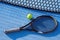 Tennis racket and ball next to net, top view