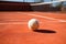 a tennis racket and ball under midday sunlight