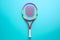 Tennis racket on colored background with copy space for ads. Colorful racket for playing tennis on light blue background.